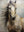 A vertical hand-painted realistic oil painting of a white stallion's head and neck with a flowing dark mane and expressive eyes against a neutral, textured background.