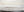 Minimalist hand-painted abstract oil painting of a sea horizon in soft grey and beige tones, styled in a modern Zen-inspired living room.