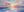 Large hand-painted impressionist oil painting of a vibrant pink and gold sunset over the ocean, hanging above a luxury gray bed in a modern master bedroom.
