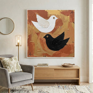 Hand-painted heavy texture oil painting of a white bird and a black bird with button eyes, flying against a textured background of gold, terracotta, and ochre brown paint strokes.