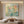 Premium handmade abstract oil painting depicting a dreamy garden with soft pastel pink flowers, sage green leaves, and warm yellow brushstrokes.