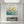 Premium handmade abstract oil painting depicting delicate blush pink flowers blooming over a rich teal, green, and gold textured background.