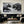 100% handmade expressionist abstract oil painting depicting a powerful bull and bear conflict in monochrome black and white tones, displayed in an executive office setting.