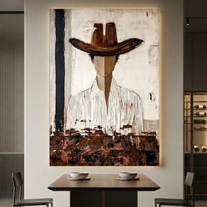 Handcrafted abstract cowboy oil painting with rich brown and white textures hanging in a modern living room