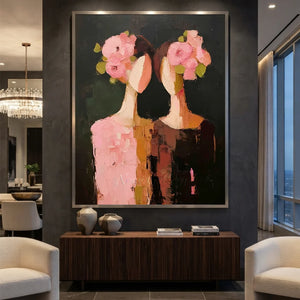 Handcrafted abstract floral oil painting featuring textured pink flowers and portraits against a dark background hanging in a modern living room