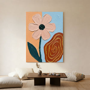 A 100% handmade abstract floral oil painting displaying a heavy-textured pastel pink flower with a dark green stem, alongside a terracotta-colored swirling pattern on a blue and orange split background.