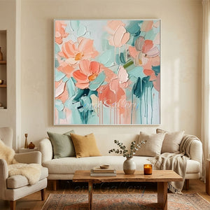 Hand-painted heavy texture abstract oil painting showing clustered blooming flowers in shades of blush pink and peach coral on a refreshing mint green and white background with artistic paint drips.