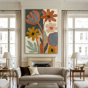A 100% handmade abstract floral oil painting with rich heavy-textured brushstrokes, displaying burnt orange, mustard yellow, and soft pink flowers with sage green leaves on a dark grey and white split background.