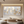Large horizontal hand-painted abstract oil painting of golden ginkgo leaves with heavy 3D texture on a misty grey and white background, styled in a modern minimalist dining room.