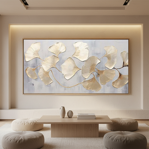 Large horizontal hand-painted abstract oil painting of golden ginkgo leaves with heavy 3D texture on a misty grey and white background, styled in a modern minimalist dining room.