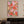 A 100% handmade abstract garden oil painting featuring a dense arrangement of heavy-textured, colorful flower petals in candy pink, coral, and yellow, painted with bold palette knife strokes.