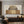100% handmade abstract geometric oil painting featuring circles and vertical lines in neutral earth tones and gold accents, displayed in a modern minimalist living room setting.
