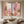 100% handmade modern abstract pastel oil painting featuring a diptych design in soft pink, beige, and earthy tones, displayed on a stylish staircase gallery wall above a white interior setting.