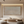 Handmade Wabi Sabi abstract oil painting featuring relief-like dots and vertical textured lines in beige and cream, hanging on a white wall in a modern staircase gallery setting.