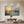 Set of two hand-painted abstract oil paintings depicting a warm golden sunrise over a misty blue landscape with visible palette knife textures and expressive brushwork.