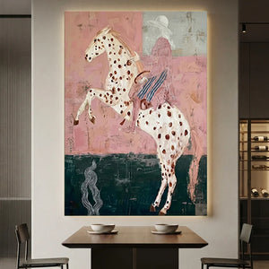 Handcrafted Americana folk art oil painting featuring a striking rider on a spotted horse against soft pink tones hanging in a modern living room