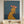 Handcrafted abstract cocktail lady oil painting with rich blue textures hanging in a modern living room or bar