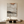 Vertical hand-painted abstract oil painting with heavy texture in beige, cream, and black, styled in a minimalist boho living room above a wooden coffee table.