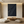 Handmade large black oil painting featuring 3D vertical ridge textures and a flowing abstract curve in a modern zen living room.