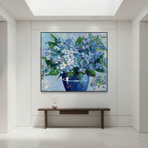 Premium handmade abstract oil painting depicting delicate blue blossoms on a textured pastel beige and gold background, rendered with rich 3D palette knife impasto.  