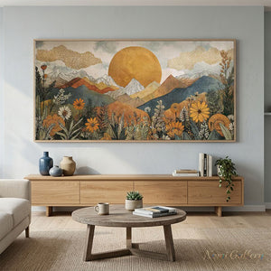 100% handmade boho mountain landscape oil painting featuring a golden sun, mountain ranges, and blooming wildflowers in warm earth tones, displayed in a modern living room setting.