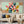 100% handmade abstract geometric floral oil painting featuring pastel color blocks and petal motifs in mint green and pink, displayed in a modern living room setting.