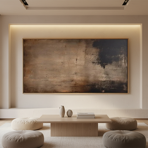 Large horizontal handmade abstract oil painting in deep brown and charcoal with weathered textures, hanging in a modern white dining room above a dark wood table with grey chairs.