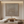 Hand-painted brown abstract oil painting featuring repetitive horizontal relief textures, styled in a minimalist boho living room above a wooden console table.