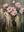 Handmade modern impressionist oil painting showcasing a bouquet of pink blooming roses with stylized vertical streaks of pink and green paint dripping down against a distressed dark forest green background.  