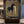 Handcrafted earth tone horse oil painting featuring a person bonding with a black horse against a textured brown background