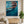 Vibrant handmade impressionist oil painting of a woman swimming underwater in the deep blue sea, with realistic light bubbles and warm sun reflections on ripples.