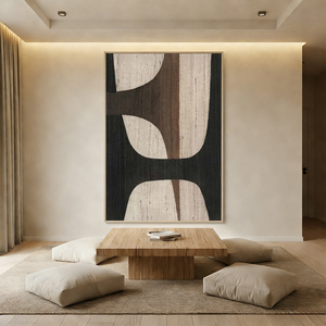Large handmade Wabi Sabi abstract oil painting on canvas featuring black and brown geometric shapes with visible fabric texture in a boho-style living room.