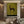 100% handmade minimalism equestrian oil painting in olive and earth tones featuring a horse and rider, displayed above a wooden credenza in a boho living room by Nomi Gallery.