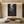Handmade minimalist Zen oil painting with creamy white semi-circular textures and 3D impasto strokes, styled in a warm boho-modern living room.