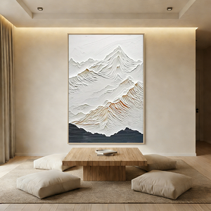 Hand-painted minimalist snow mountain oil painting with heavy 3D impasto texture in white and grey, styled in a bright modern boho living room.