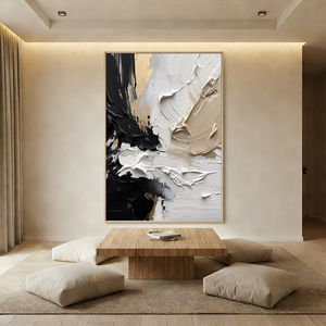 Hand-painted abstract oil painting with thick 3D impasto texture in black, white, and gold, displayed in a bright modern boho living room above a beige sectional sofa.