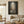 Hand-painted mystical oil painting showcasing a single classical pedestal standing in dark water under a stone archway, illuminated by a bright overhead beam of light.