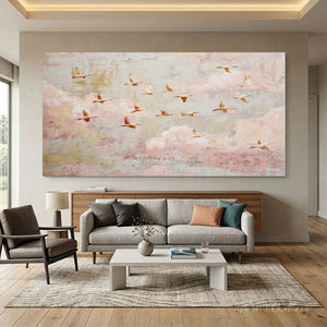 100% handmade impressionist birds in flight oil painting featuring a flock soaring through a soft pink and neutral sky, displayed in a modern living room setting.