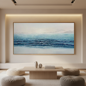 Hand-painted 3D textured abstract painting of blue ocean waves with heavy white impasto foam, displayed in a bright modern coastal-style living room.