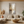Modern light luxury hand-painted abstract oil painting with gold leaf accents and heavy texture, displayed in a bright minimalist living room setup.