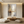 Modern light luxury hand-painted abstract oil painting with gold leaf accents and heavy texture, displayed in a bright minimalist living room setup.