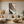 Close-up of a hand-painted heavy texture abstract oil painting with 3D layered ridges in mocha and cream tones, enhancing a minimalist interior.