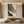 Close-up of a hand-painted heavy texture abstract oil painting with 3D layered ridges in mocha and cream tones, enhancing a minimalist interior.