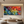 Close-up of a hand-painted 3D abstract oil painting featuring thick impasto texture in vibrant red, blue, and yellow strokes, styled for a modern minimalist living room.