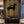 Handcrafted expressionist oil painting featuring a stylized rider on a black horse in earthy tones, displayed above a dining table for elegant restaurant wall decor.