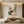 Hand-painted Wabi-Sabi abstract oil painting with geometric shapes in sage green, blush, and beige, featured in a bright boho living room above a cream sofa.