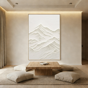 Hand-painted 3D textured white mountain oil painting with heavy impasto ridges, displayed in a minimalist boho living room above a beige sectional sofa.