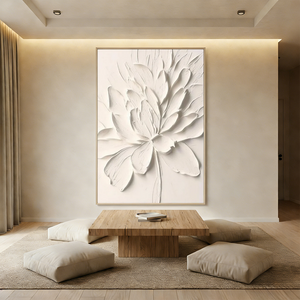 Hand-painted 3D textured white flower oil painting with thick impasto petals, displayed in a bright boho living room above a cream-colored sofa.