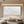 Large handmade white oil painting of a crashing ocean wave with heavy 3D impasto texture, styled in a minimalist modern living room above a wooden console table.