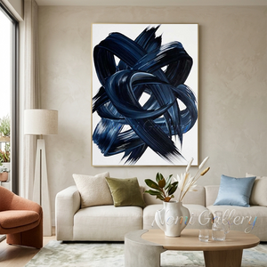 Large hand-painted abstract oil painting showcasing dynamic, thick swirling brushstrokes of navy and midnight blue on a white canvas, displayed over a low wooden table in a minimalist boho living room.